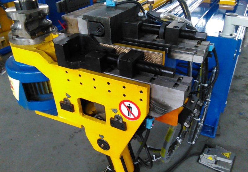 CNC tube bender: bending dies and clamping head close-up