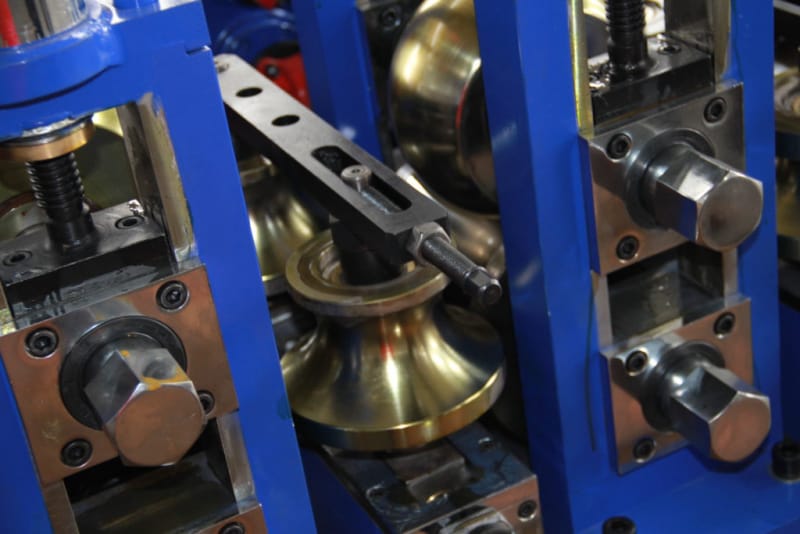 HG32 welded pipe machine: forming stand close-up with brass forming rolls