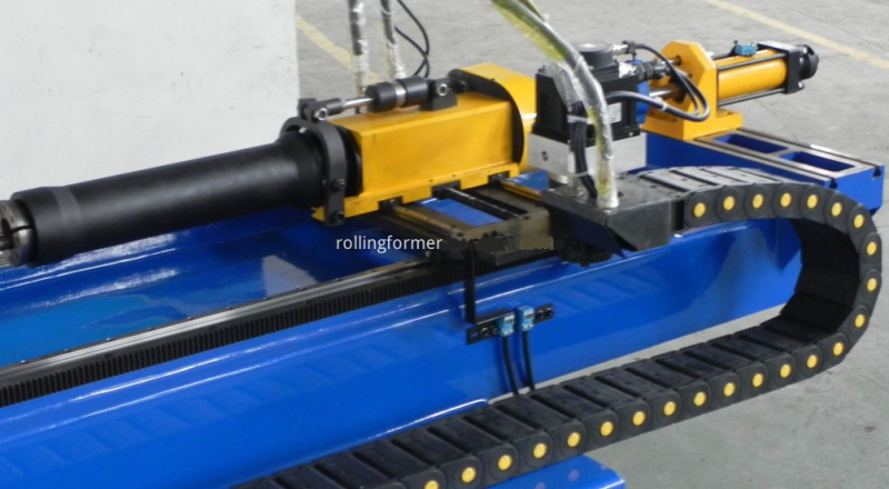 CNC tube bender: feed carriage and bending arm close-up