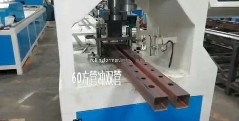 Double station holes profile channel punching machine: square tube being punched in the die