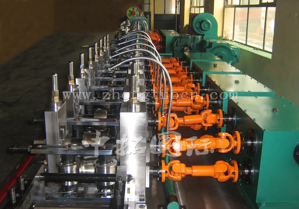 Close-up of forming rolls and metal strip entering a tube mill