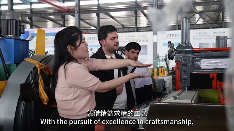 Kazakhstan customer inspecting a welded pipe machine in the Zhongtuo workshop
