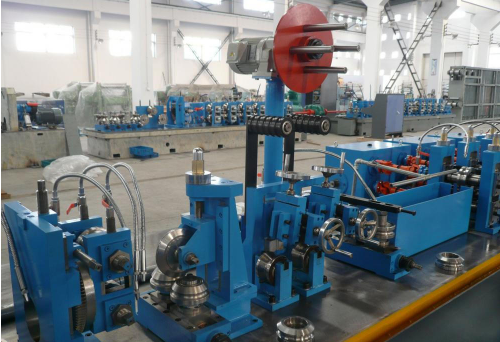 Steel welded tube roll forming machine: shear and welding unit in the workshop
