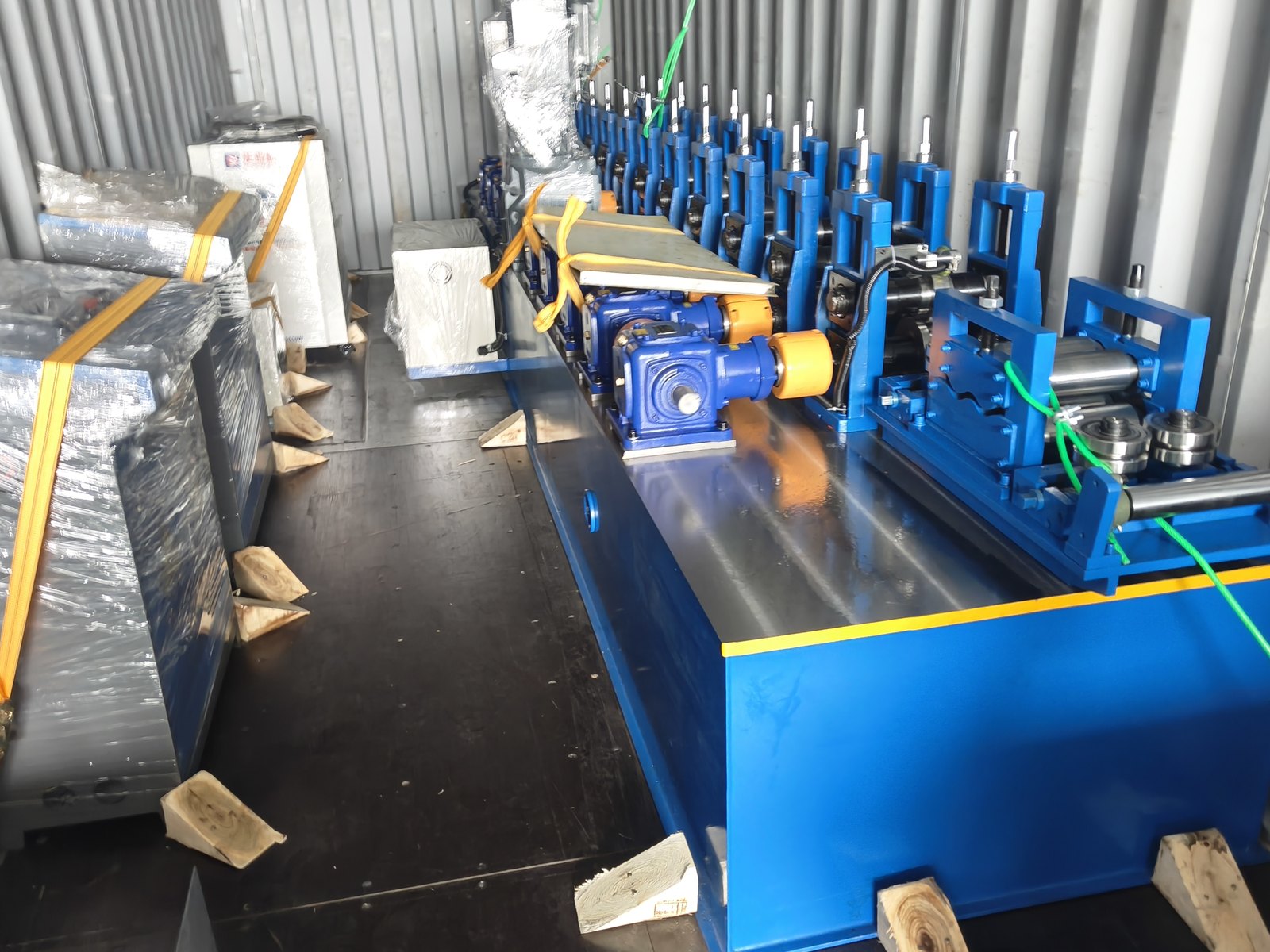 Machine unit of the tube line secured inside a shipping container