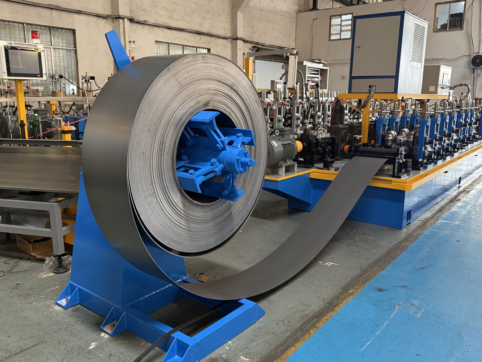 Coil on the decoiler at the entry of a laser welded tube mill line