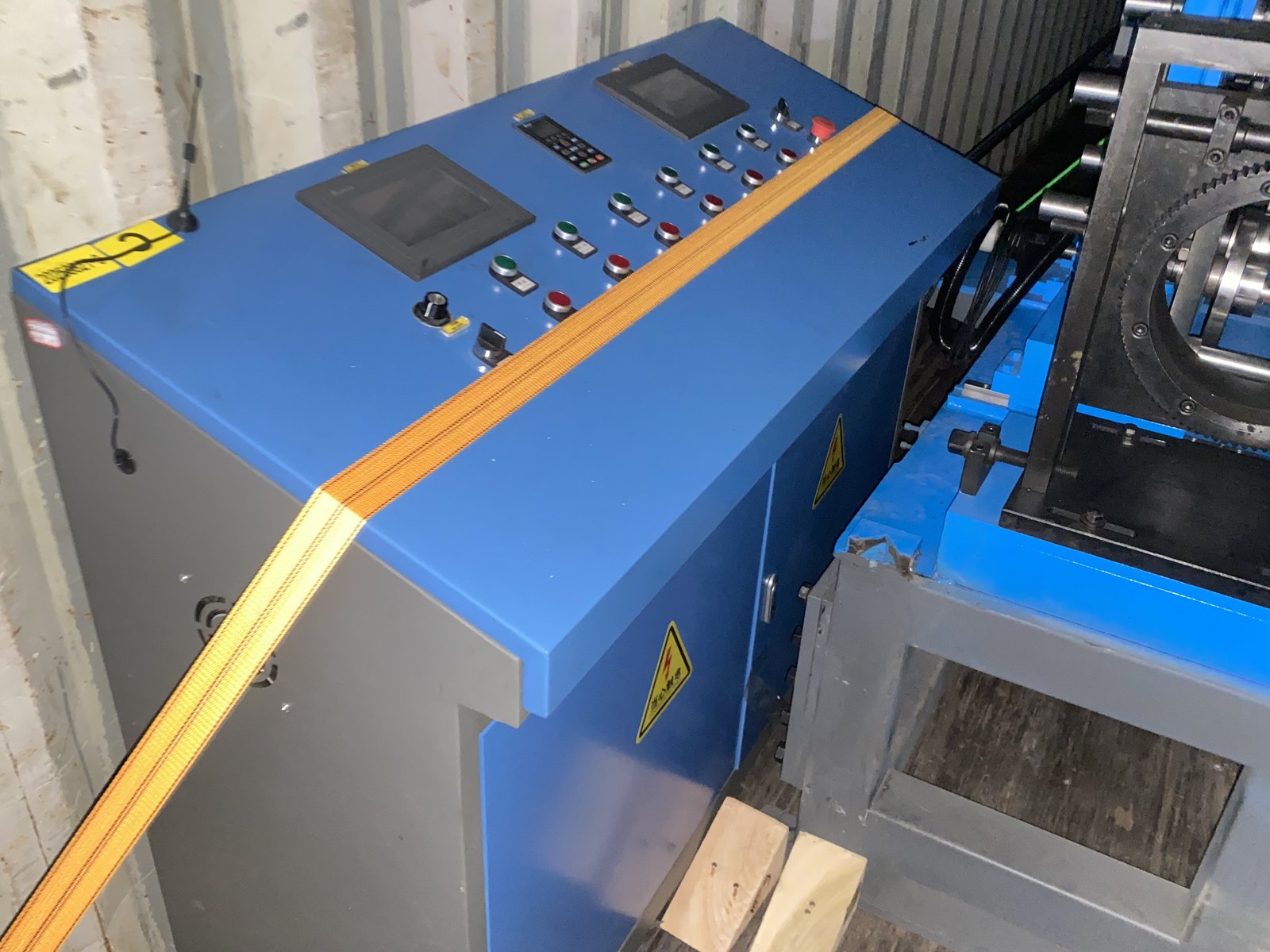 Control cabinet and operator screen of a roll forming line, packed for dispatch